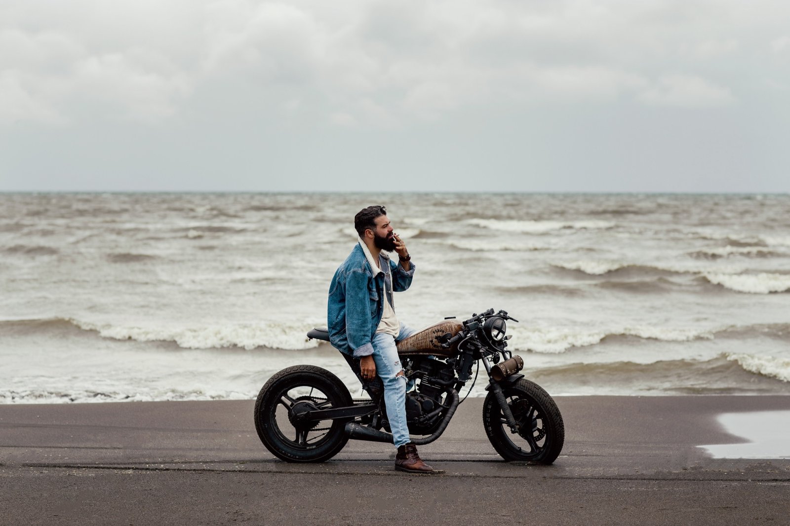 Niko Kane beside a motorcycle in a cinematic short film scene